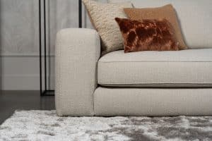 Beiges Sofa mit verschiedenen Elementen und ansprechendem rot/pinkem Innendesign.