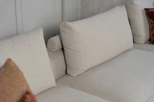 Beiges Sofa mit verschiedenen Elementen und ansprechendem rot/pinkem Innendesign.